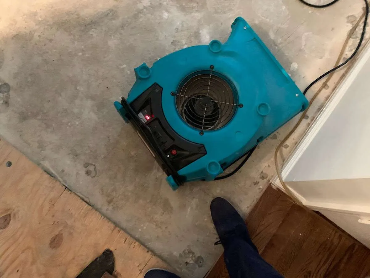 Air mover drying subfloor during Commercial Water Damage Restoration in New Albany